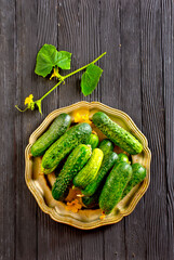 Fresh and healthy organic cucumbers served on metal plate.