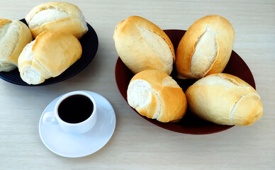  Some French Bread Dinner Rolls on the table and cup of coffee 
