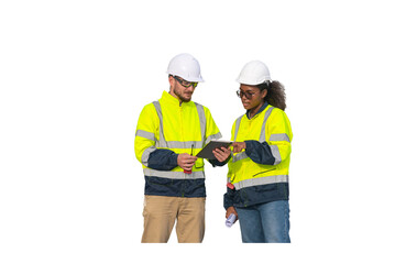 Engineers wearing safety gear, including hard hats examining survey a large blueprint laptop.