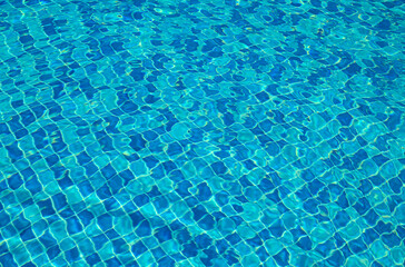 Blue water surface viewed from above in outdoor , sun reflection, dimply