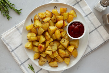 Homemade Oven Roasted Potatoes with Ketchup on a Plate, top view.