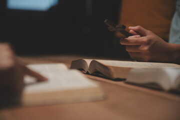 Christian group are praying to god with the bible and sharing the gospel. Concept of faith for god.