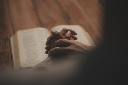 Christian group are praying to god with the bible and sharing the gospel. Concept of faith for god.