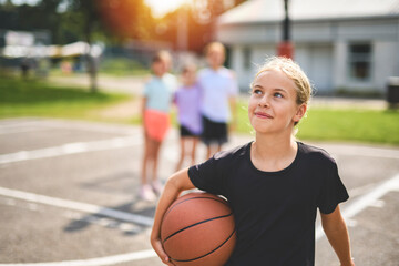 Childs girls Team in sportswear playing basketball game