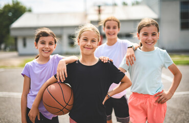 Childs girls Team in sportswear playing basketball game