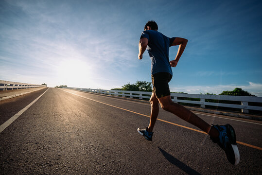 runners is running on the road at outdoors , healthy lifestyle and sport concepts.