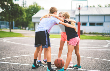 Childs girls Team in sportswear playing basketball game