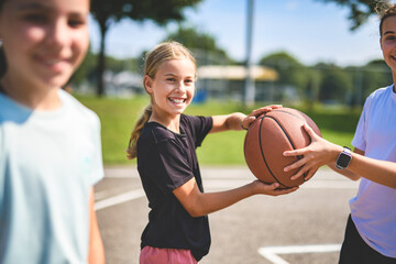 Childs girls Team in sportswear playing basketball game