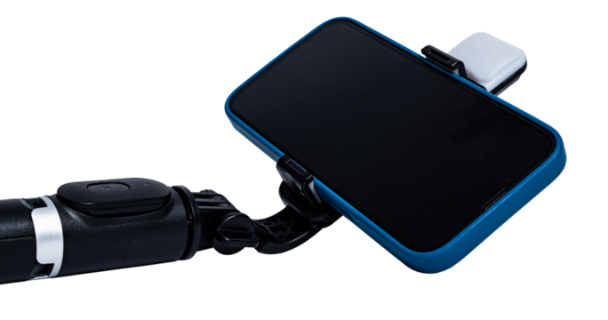 Selfie stick and smartphone on transparent background