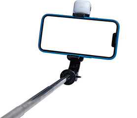 Selfie stick and smartphone on transparent background with transparent cut out screen.