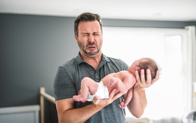 Father change diaper to baby girl on a baby changing table
