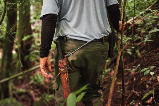 Man hiking through Costa Rican jungle with machete