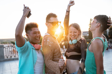 Joyful LGBTQIA+ friends celebrating at sunset