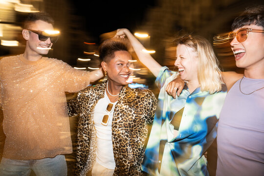 Joyful LGBTQIA+ friends enjoying a night out together