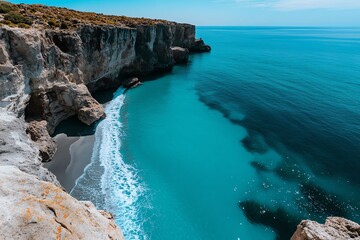 Obraz premium Forever Summer with a seaside cliffside view, captured in a photo where the ocean stretches out to the horizon, with waves crashing against the rocks below