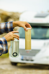 Person showing aqua filter cartridge used in caravan.