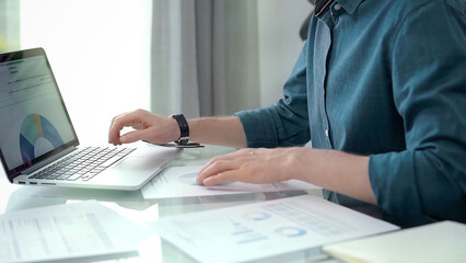 Professional working at laptop with data analysis charts. Businessman analyzing statistical data on...