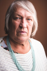 Closeup portrait of a pensive old lady. Elderly woman looking