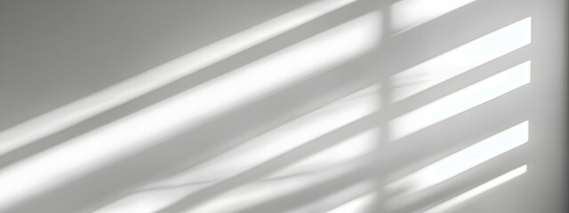 Obraz premium Minimal blurred natural light rays casting trace monotone soft shadows on a clean white wall creating a serene calming and elegant abstract composition