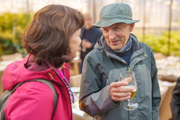 Man and woman chatting in a greenhouse at Fridheimar