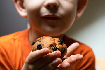 Kid eats sweet food. Focus on the food and face on background