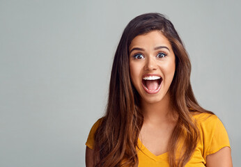 Woman, portrait and surprise in studio for secret, announcement and news information with smile. Female person, face and shock on gray background for sale, deal and wow with omg, wtf or coming soon