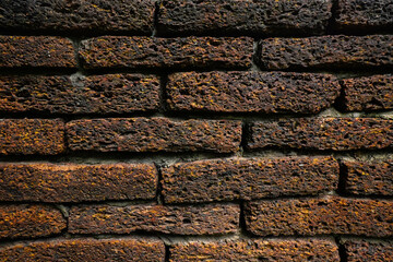 Empty old red grain stone brick wall made with antique blocks for abstract seamless background and texture. beautiful patterns, space for work, close up.