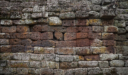 Old brown white grain stone brick wall made with antique blocks for abstract seamless background and texture. beautiful patterns, space for work, close up.