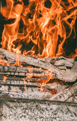 Close-up of a fire in a barbecue. Large coals burn strongly.
