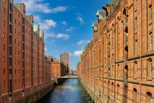 Looking down a canal between the old restored warehouses of Speicherstadt in Hamburg, Germany