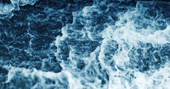 Super slow motion macro of powerful river flowing stream of cold fresh pure water crushing waves with splashing drops perfect for extreme sports as kayak rafting, filmed at 1000 fps.