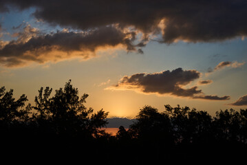 Beautiful sunset over the forest trees, aerial view