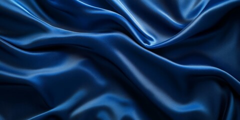Obraz premium Dark blue satin fabric with soft folds.