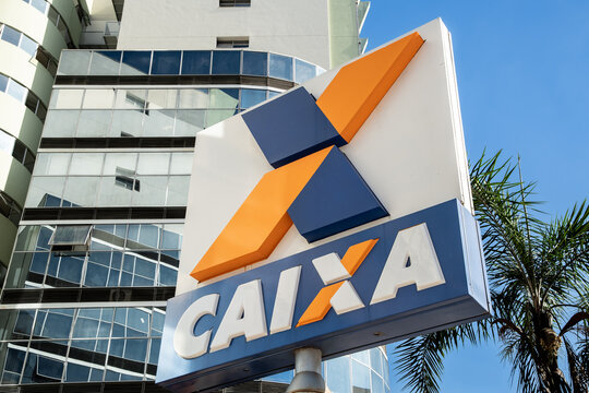 signbord with the logo of Caixa Economica Federal. The federal bank of Brazil. A building in the background