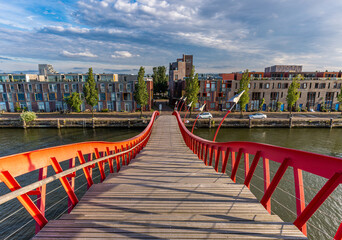 Eastern Docklands neighborhood in Amsterdam oost seen from the red pedestrian Python Bridge