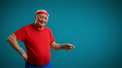 Humorous senior man pointing to empty space on blue background, advertisement