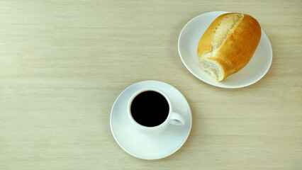  French Bread on the plate and cup of coffee with copy space.
