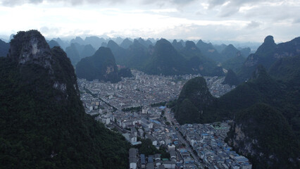 aerial view of the city of Yangshuo surrounded by green mountains, China