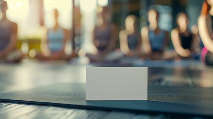 Fototapeta premium Serene Fitness Studio Session With Empty Business Card on Yoga Mat During Morning Class