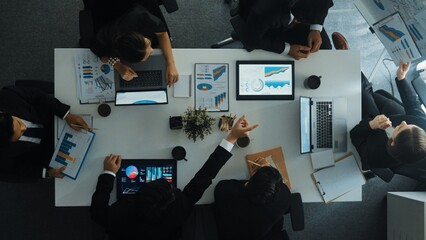 Top view of smart manager project writing at chart while looking at data. Project manager explain...