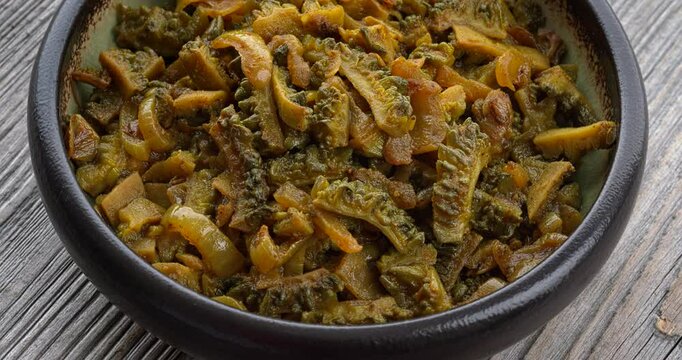 Bitter gourd curry (Karela Sabji in Hindi) with onion, dry mango powder, and spices. Table spin. 