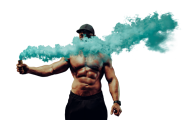 Young strong man bodybuilder standing with dense blue smoke on urban industrial background