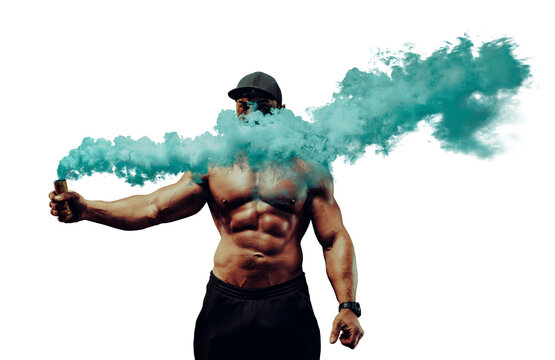 Young strong man bodybuilder standing with dense blue smoke on urban industrial background - Powered by Adobe