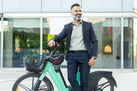 Indian businessman with electric bike in urban setting
