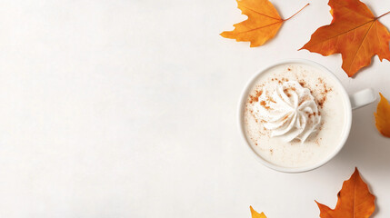 A cozy autumn scene featuring a pumpkin spice latte topped with fluffy whipped cream and dusted with cinnamon, placed on a light, neutral background. The drink is presented in a st
