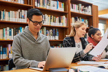Laptop, typing and man in library for study with university, education and scholarship for growth....