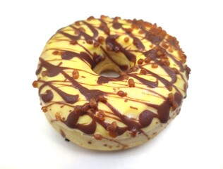 Photo of a mouthwatering chocolate and caramel doughnut, isolated on white background.