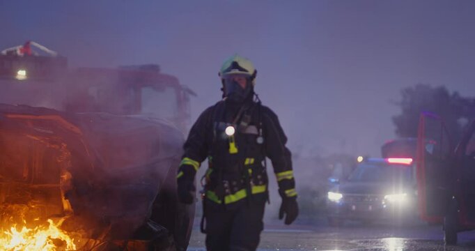 Portrait of a heroic fireman in a protective suit. Firefighter in fire fighting operation.