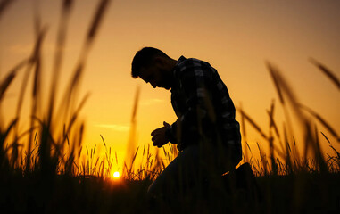 Prayer concept. Silhouette of a man in a praying pose. On his Knees forgiveness. vibrant sunset sunrise sky. Clasped hands lonely. sacrifice, sincerity , sanctification, shepherd, trinity, shadow