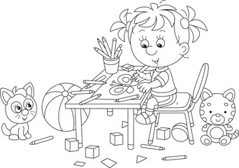 Smiling little girl sitting at her table and drawing with pencils a funny picture, black and white vector cartoon illustration for a coloring book